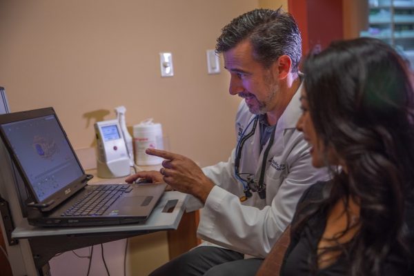 Dr. Darren Dickson and patient going over treatment plan
